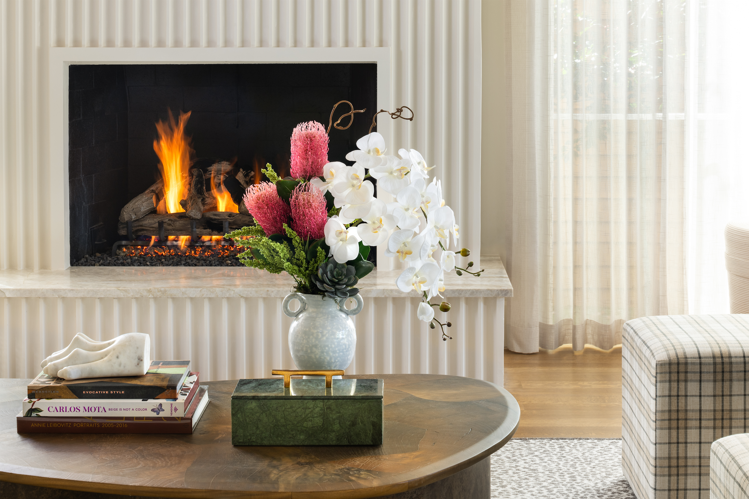 Contemporary yet Elegant Faux Orchid Centerpiece decorating the coffee table in a Luxury Dallas home.