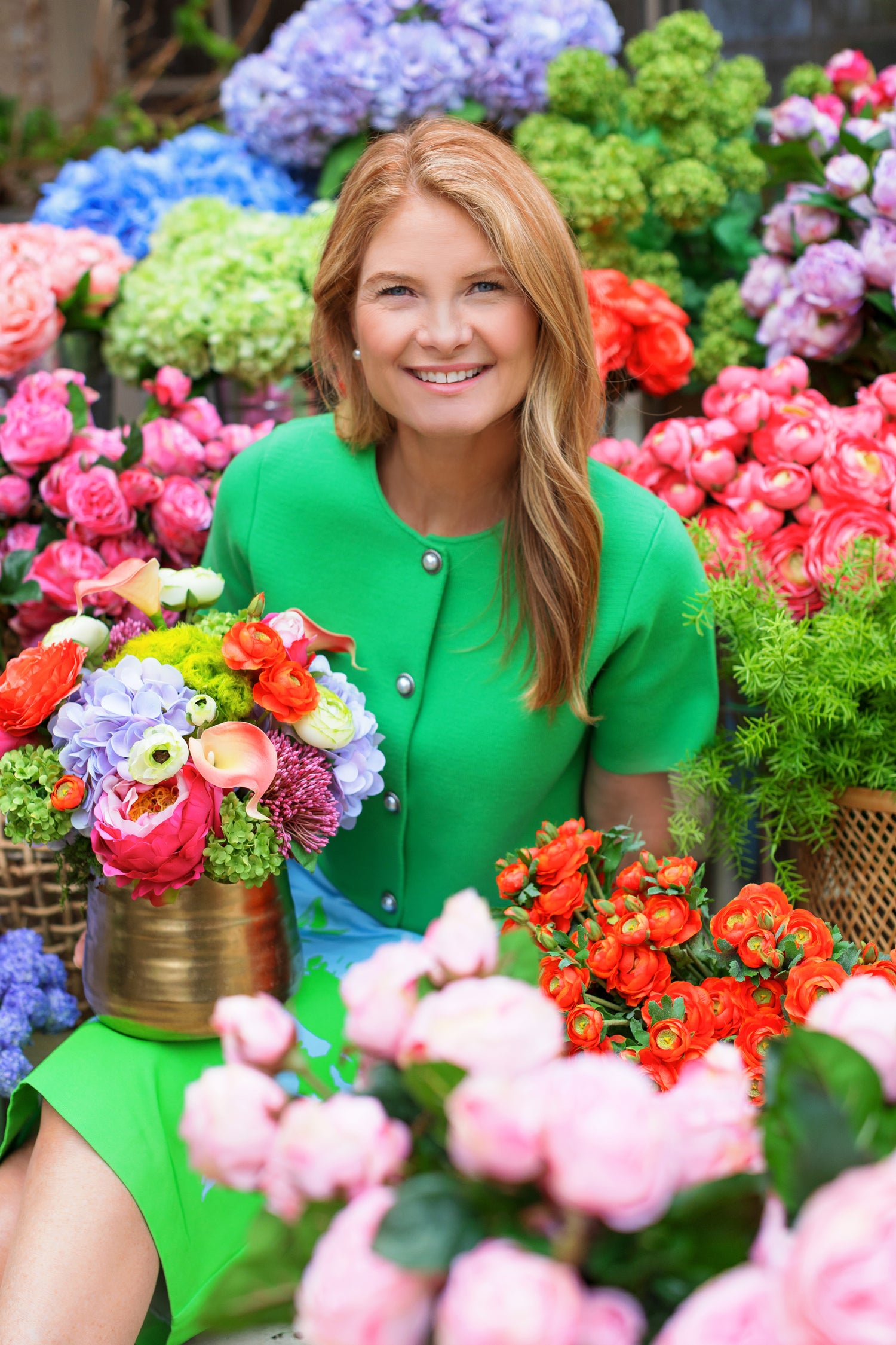 Owner & Founder Ashley surrounded by beautiful faux florals