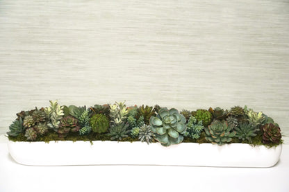 A Long White trough filled with a beautiful variety of Artificial Succulents. A truly luxurious look for your dining room table.